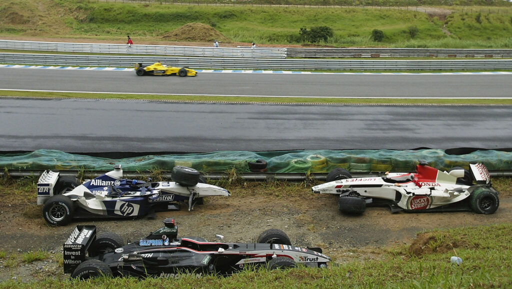 Damaged cars are seen on the turn 3 corner during 2003 Brazilian GP.