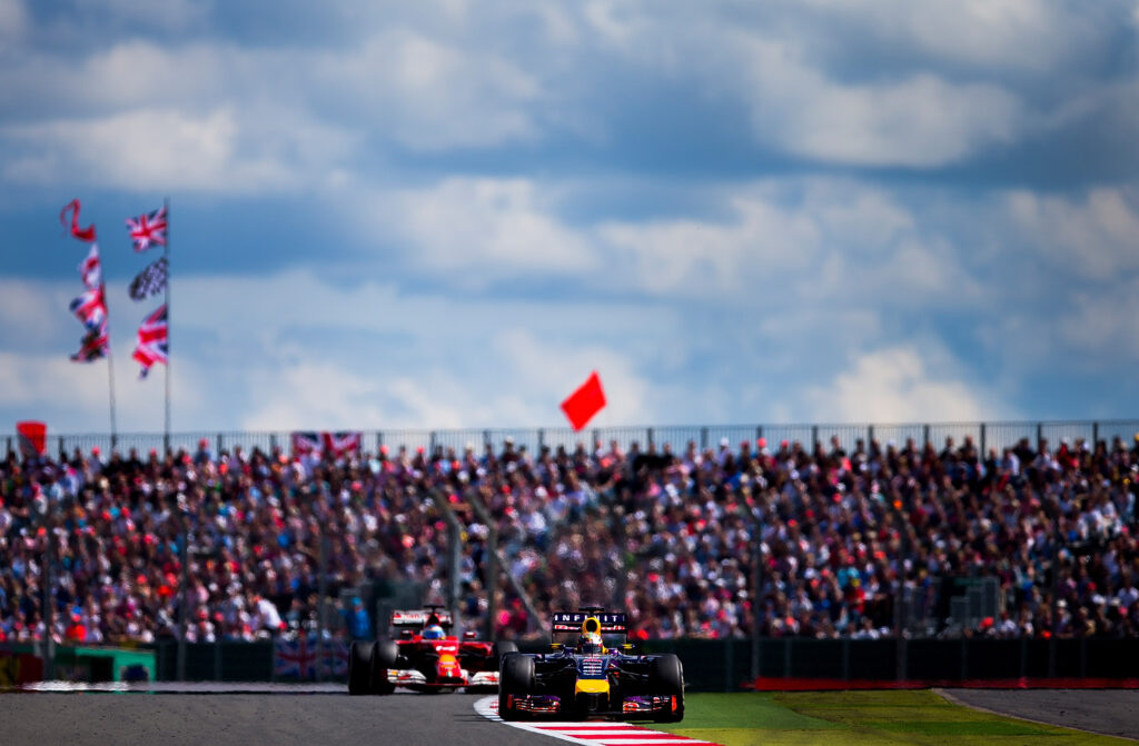 Fernando Alonso chases Sebastian Vettel at the 2014 British GP.
